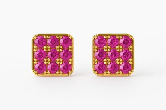 Square gold stud earrings featuring a grid of vivid red rubies set in a rounded-edge frame, with delicate gold bead prongs accentuating each stone. Displayed on a soft cream background with a subtle reflection.