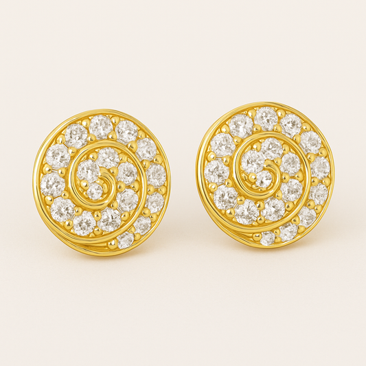 A pair of round gold stud earrings featuring a spiral design set with vibrant white diamonds. Each earring showcases 14 gemstones intricately arranged along a golden swirl pattern, displayed against a soft cream background.