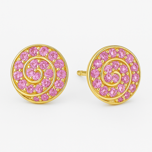 A pair of round gold stud earrings featuring a spiral design set with vibrant pink sapphires. Each earring showcases 14 gemstones intricately arranged along a golden swirl pattern, displayed against a soft cream background.